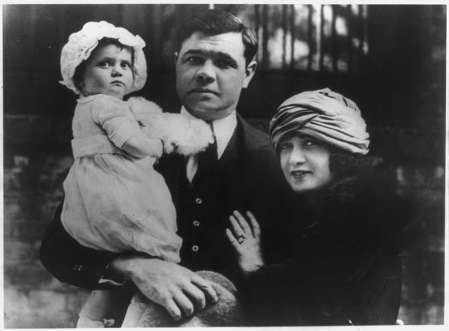 Dorothy in the arms of her father, Babe Ruth, with his wife, Helen, 1925.