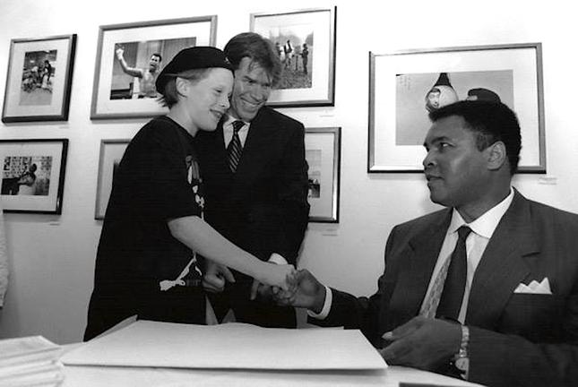 Young David Murray and Govinda Gallery owner Chris Murray meet Muhammad Ali in 1995.