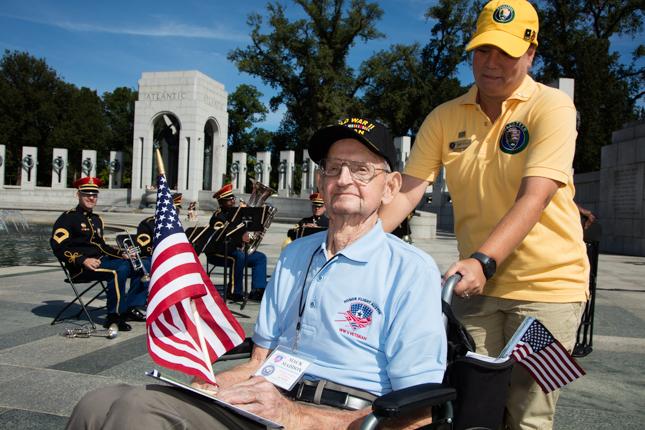 Oscar Maddox, age 96, of Nacogdoches, Texas, is escorted by National Park Service volunteer Sandy Lamparello.