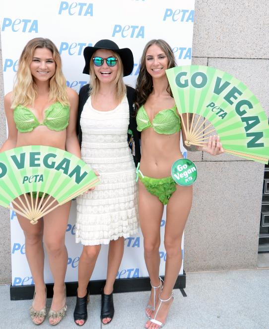 House staffer Sarah Nazar (center) greets a pair of PETA's Lettuce Ladies.