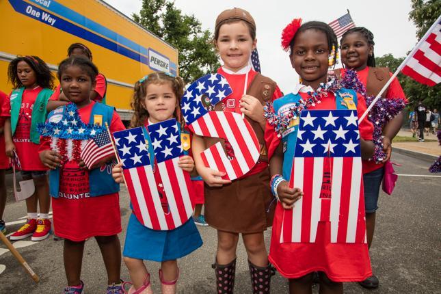 Girl scouts spell USA at last year's parade.